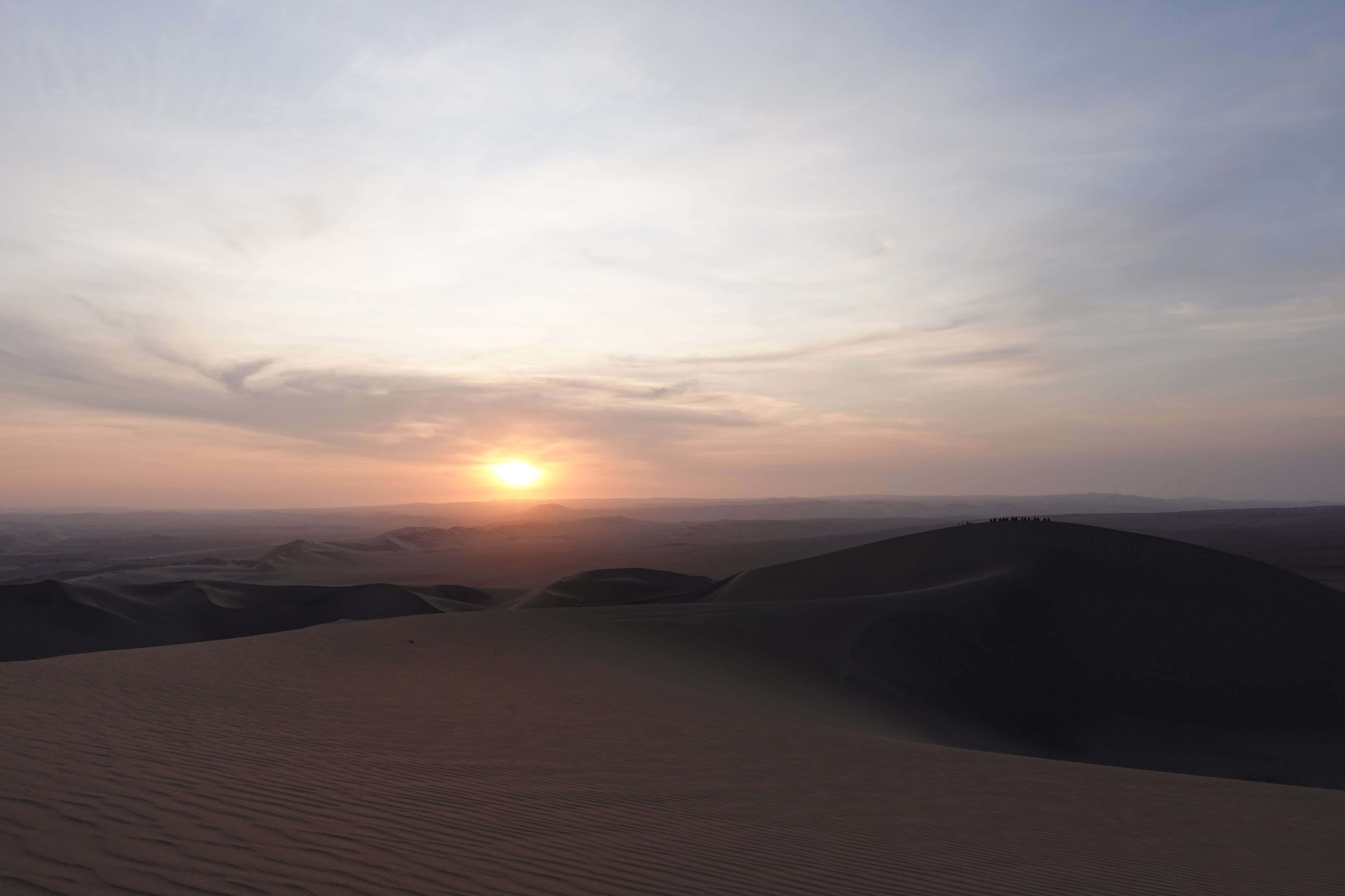 The sunset over the desert near the Huacachina Oasis.